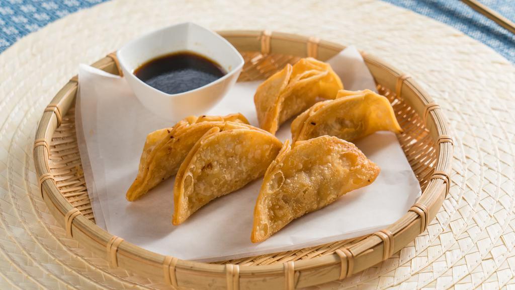 Gyoza · Chicken, cabbage, garlic, ginger, scallion, and sesame oil. Served with soy sauce.