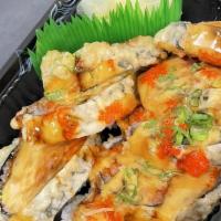 Dinosaur Roll · Tempura fried spicy tuna, fish Roe, scation, eel sauce and spicy mayo.
