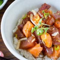 Poke Bowl · Seasoning tuna, salmon, avocado and cucumber over sushi rice.