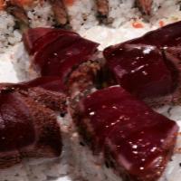 Amazing Tuna Roll · White tuna tempura, spicy tuna, avocado topped with pepper tuna, masago, and special sauce.