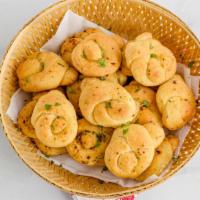 Garlic Knots · Bread, topped with garlic & olive oil and herb seasoning, baked to perfection.