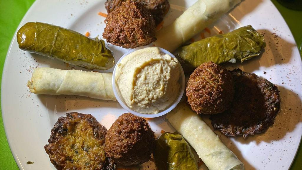 Istanbul Sampler · Includes 3 pieces of cheese rolls, 3 pieces of falafel, 3 pieces of stuffed grape leaves & 3 pieces of zucchini pancakes. Comes with side of hummus dip.