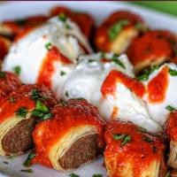 Beyti Kebab · Grilled Adana & mozzarella cheese wrapped with tomato on lavash topped with tomato sauce. Se...
