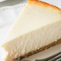 New York Cheesecake · creamy cheese cake with strawberry sauce drizzle