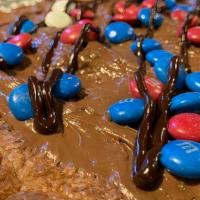 Chocolate Chip · 12 inch Chocolate Chip Cookie topped with chocolate Fudge and M&M