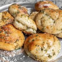 Garlic Knots · Three knots, tossed in olive oil and fresh garlic.