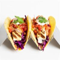 Fried Fish Tacos · 2 fried fish tacos with a cabbage slaw, pico de gallo, and sour cream in a flour tortilla.