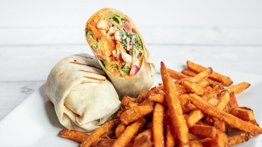 Buffalo Chicken Wrap · Crispy chicken tossed in homemade, spicy buffalo sauce, crisp romaine, tomatoes and red onions in our fresh blue cheese dressing.