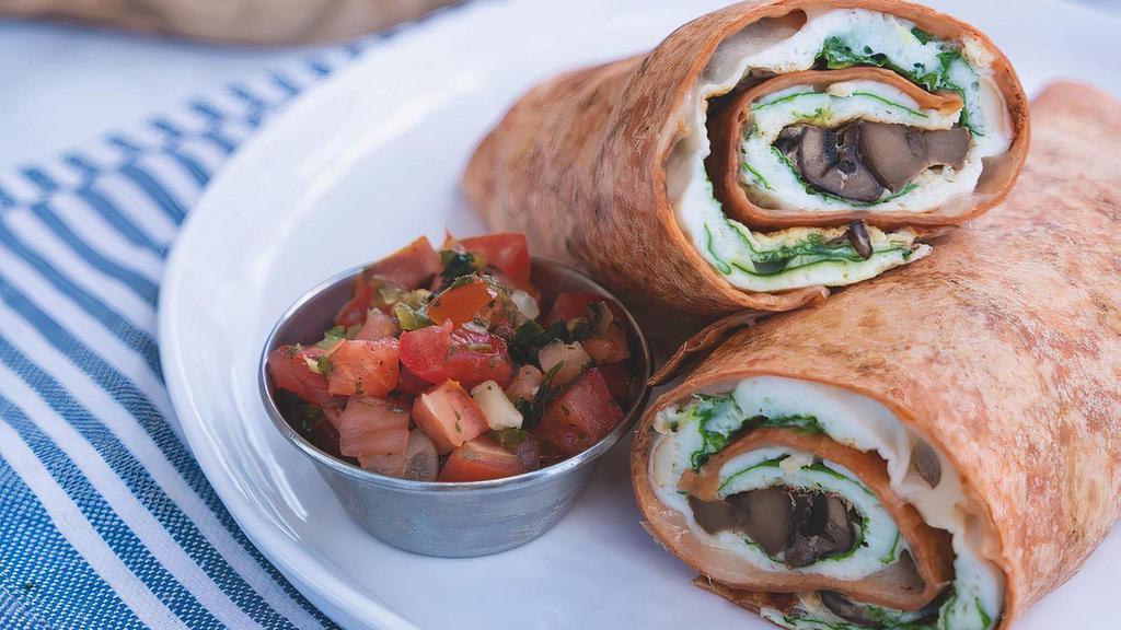 Power Wrap · Egg whites, turkey, spinach, house-roasted Crimini mushrooms and Mozzarella in a sun-dried tomato-basil tortilla. Served with fresh fruit and a side of housemade pico de gallo.