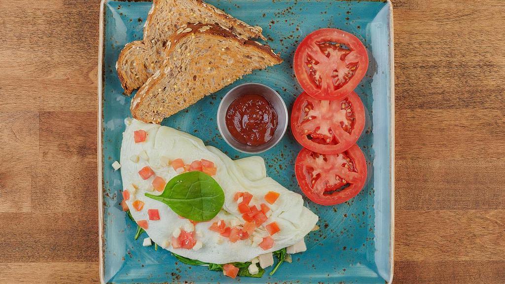 Healthy Turkey · Egg white omelet with turkey, house-roasted onions, tomatoes, spinach and Feta. Served with dry whole grain artisan toast and all-natural house preserves.