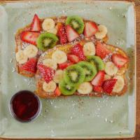 Floridian French Toast · Thick-cut brioche bread with wheat germ and powdered cinnamon sugar, covered with fresh bana...