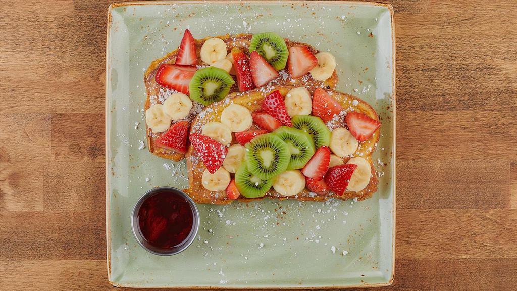 Floridian French Toast · Thick-cut brioche bread with wheat germ and powdered cinnamon sugar, covered with fresh banana, kiwi and seasonal berries..