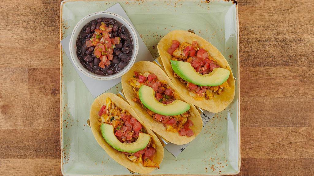 Farm Stand Breakfast Tacos · Three wheat-corn tortillas with cage-free scrambled eggs, Cajun chicken, chorizo, Cheddar and Monterey Jack. Topped with fresh avocado and housemade pico de gallo. Served with seasoned black beans. .
