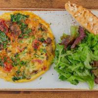 Frittata Rustica · A classic Italian-style omelet with kale, house-roasted Crimini mushrooms, onions and tomato...