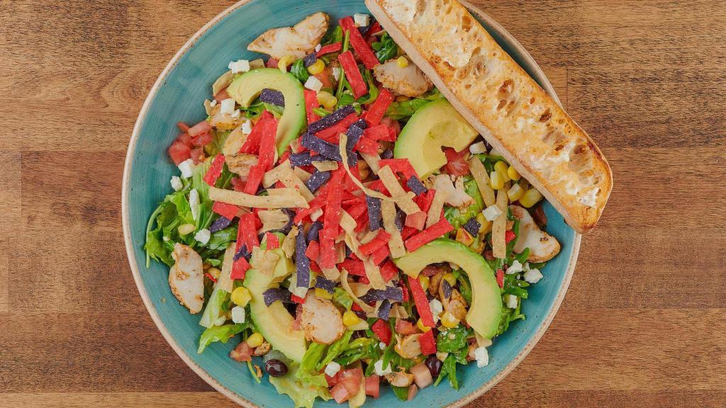 Chicken Avocado Chop Salad · Chopped romaine and arugula, all-natural chicken breast, avocado, tomatoes, corn, black beans, Feta cheese and crispy tortilla chips with a citrus chipotle dressing. Served with artisan ciabatta toast.
