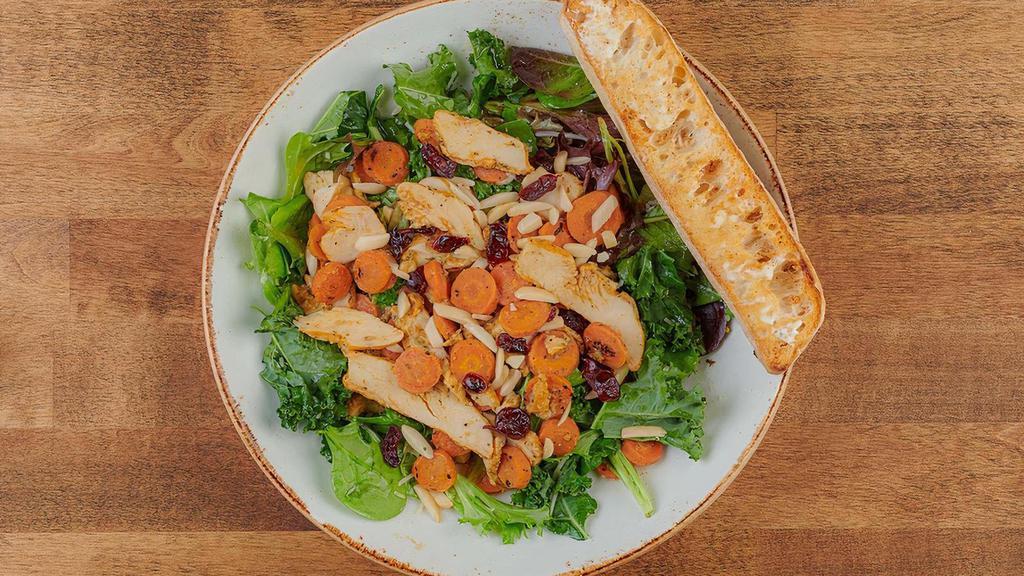 Superfood Kale Salad · Vitamin-rich kale and organic mixed greens with housemade maple-roasted carrots, warm all-natural chicken breast, dried cranberries, slivered almonds and shredded Parmesan cheese tossed in our refreshing maple-lemon vinaigrette. Served with artisan ciabatta toast.
