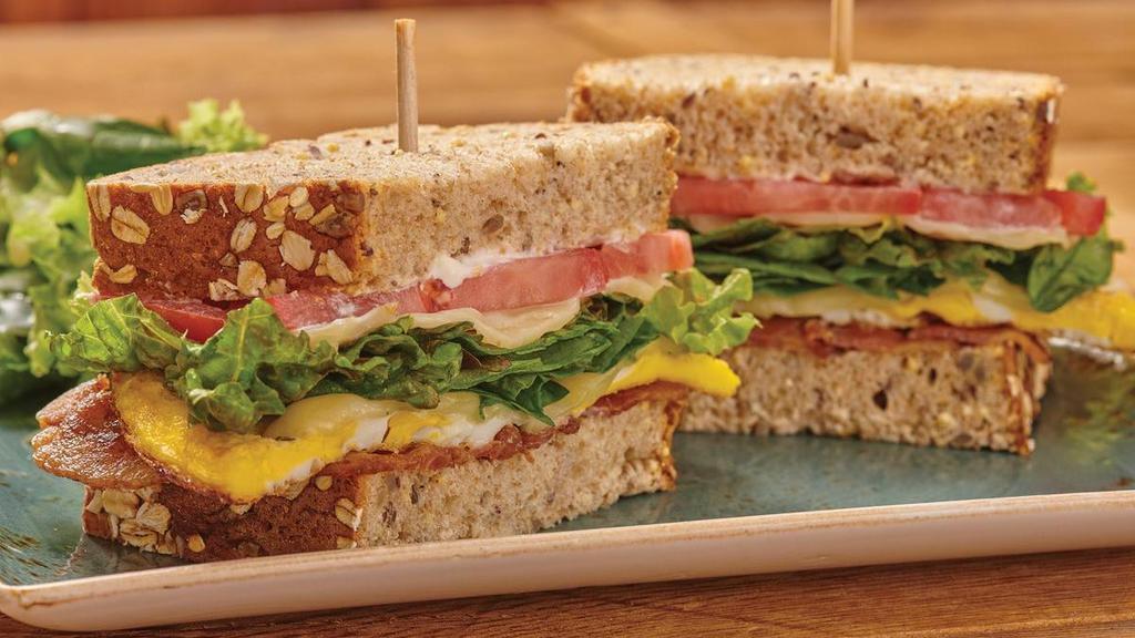 Blte · The classic BLT plus two over-hard cage-free eggs, Monterey Jack and mayo on artisan whole grain. Served with lemon-dressed organic mixed greens or a bowl of tomato basil soup.