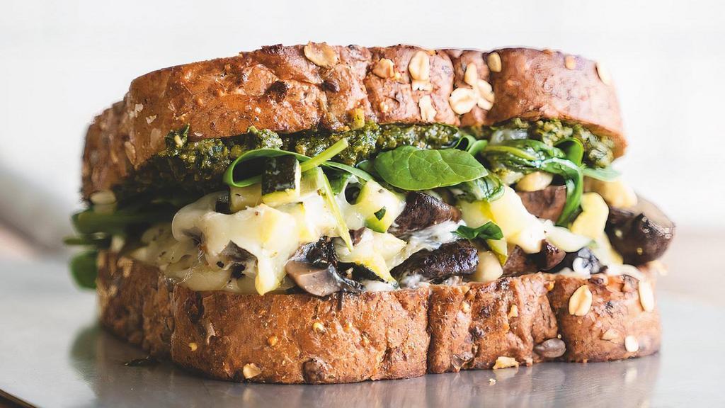 Market Veggie Sandwich · House-roasted Crimini mushrooms, zucchini and spinach with basil pesto, mayo and Mozzarella cheese on grilled artisan whole grain. Served with lemon-dressed organic mixed greens or a bowl of tomato basil soup.