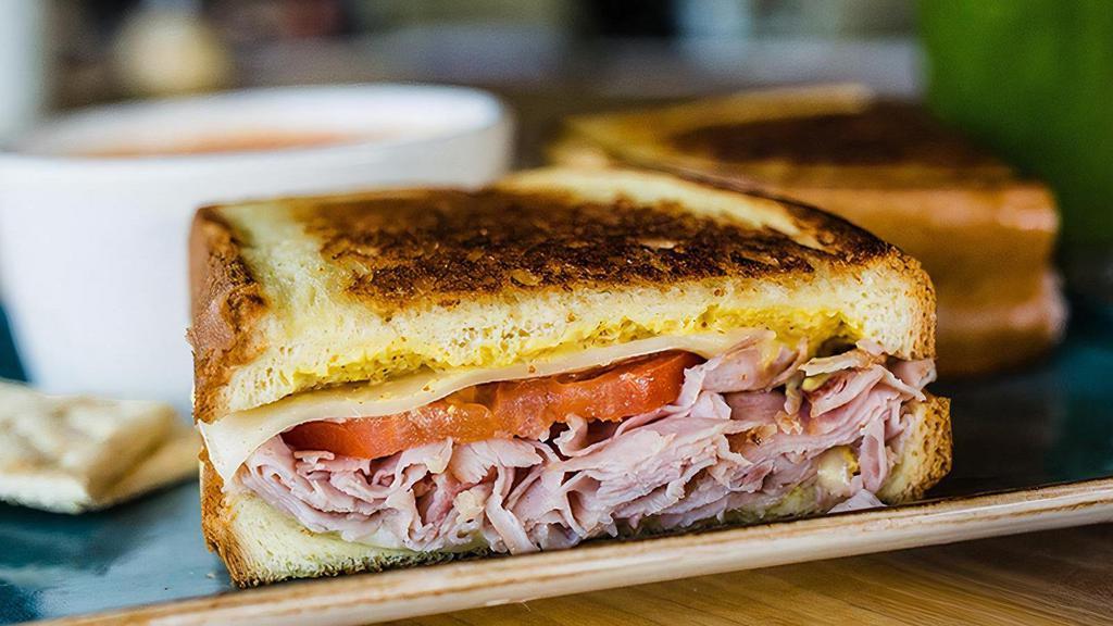 Ham & Gruyere Melt · Smoked ham, tomato, and melted gruyere cheese with dijonnaise on grilled artisan brioche. Served with lemon dressed organic mixed greens or a bowl of tomato basil soup.