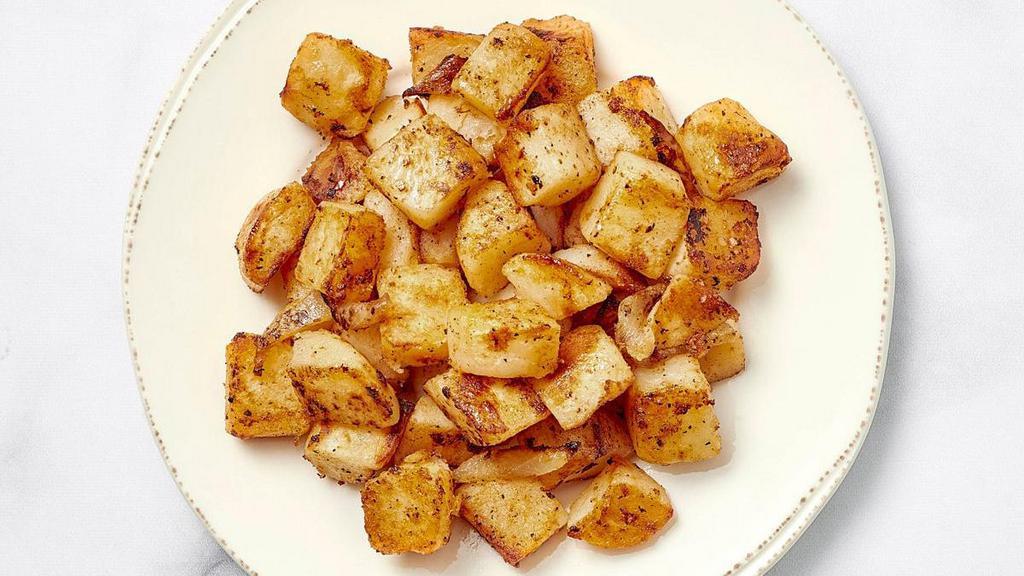 Fresh Seasoned Potatoes · Fresh, seasoned potatoes seared on the griddle with a hint of onion