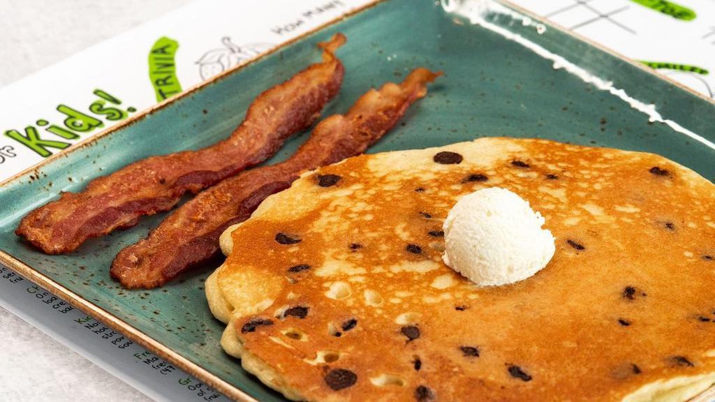 Kids Chocolate Chip Pancake · One of our humongous multigrain pancakes. loaded with chocolate chips and topped with. creamy butter. Served with your choice of. bacon or sausage.