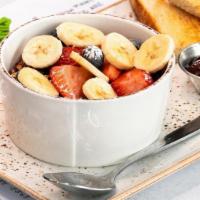 Kids Granola Bowl · Non-fat vanilla Greek yogurt topped with our. housemade granola with almonds, bananas,. stra...