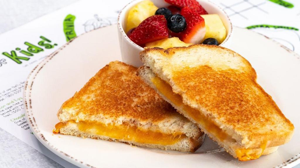 Kids Grilled Cheese · Ooey-gooey cheese melted between two pieces. of grilled sourdough bread. Served with fresh. fruit.