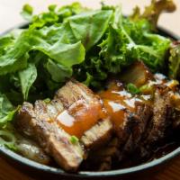 Bo Ssam · Steamed pork belly with ssam lettuce and sauce.
