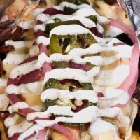 Frito Pie · BAG OF FRITOS w/Texas Red Chili, Queso, Pickled Jalapenos, Red Onions & Lime Crema