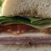 Tuscan Wedge · With prosciutto, salami, country ham, sweet peppers, provolone, tomato, greens and balsamic ...