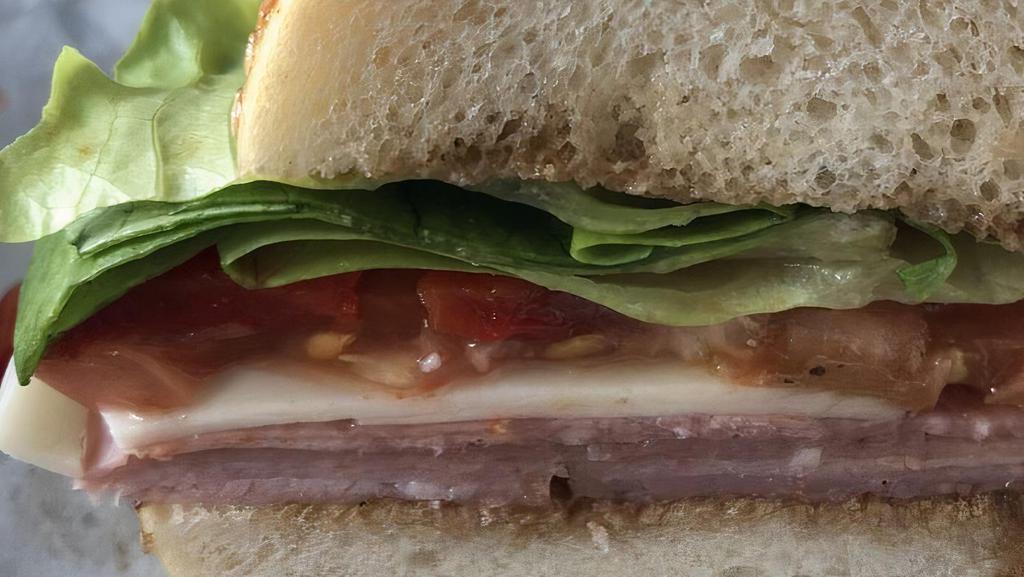 Tuscan Wedge · With prosciutto, salami, country ham, sweet peppers, provolone, tomato, greens and balsamic vinaigrette.