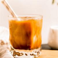 Iced Latte · Deep, dark espresso shots with steamed milk over ice.