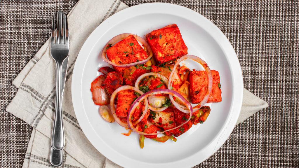 Paneer Tikka · Homemade cottage cheese skillfully blended with herb and spice, roasted in tandoor on skewers.