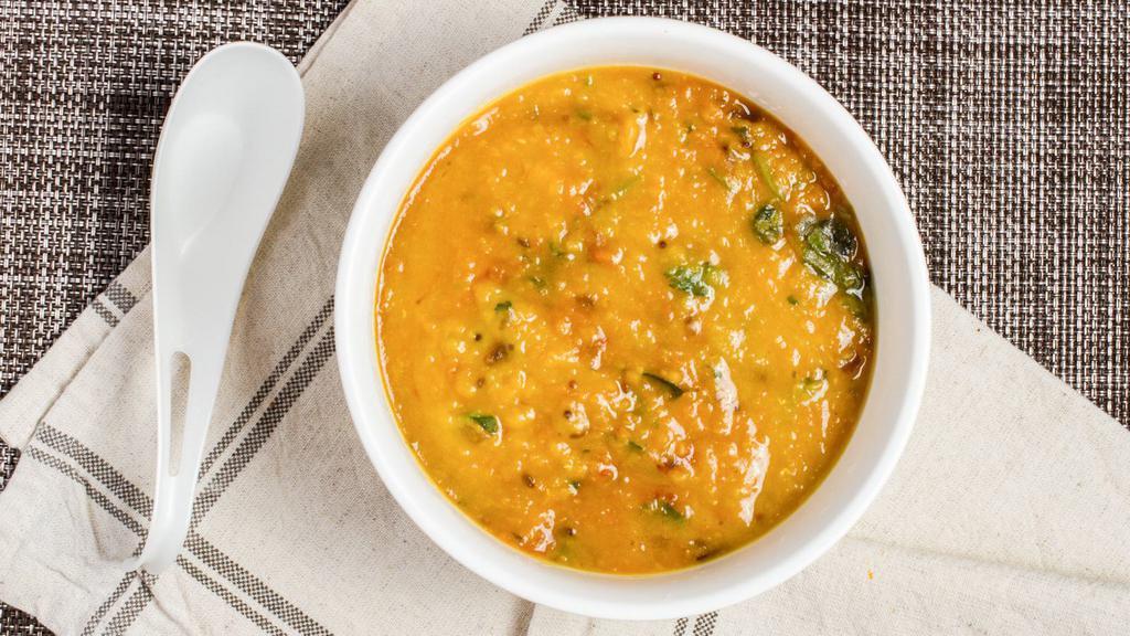 Dal Tadka · Yellow lentil cooked with garlic, cumin, onion, tomatoes and curry leaves.