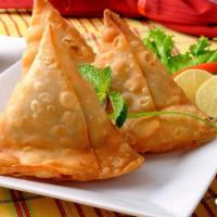 Samosa · Crispy, deep-fried triangular pastry, filled with potatoes and green peas, and flavored with...