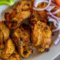 Bihari Tikka · Boneless chicken cooked with mustard oil sautéed with Indian spices, ginger, and yogurt.