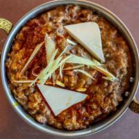 Dal Makhani · Black beans and lentils simmered in cream, lightly fried in butter with fresh onions, ginger...