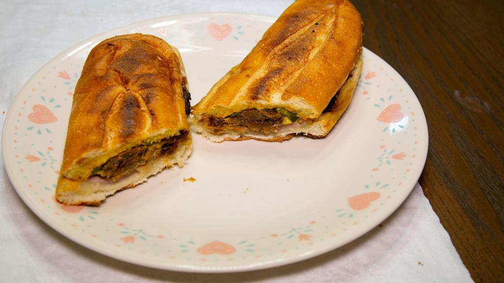 Cuban Sandwich · Special. Roasted pork, ham, Swiss cheese, pickles, mustard, and garlic mojo.