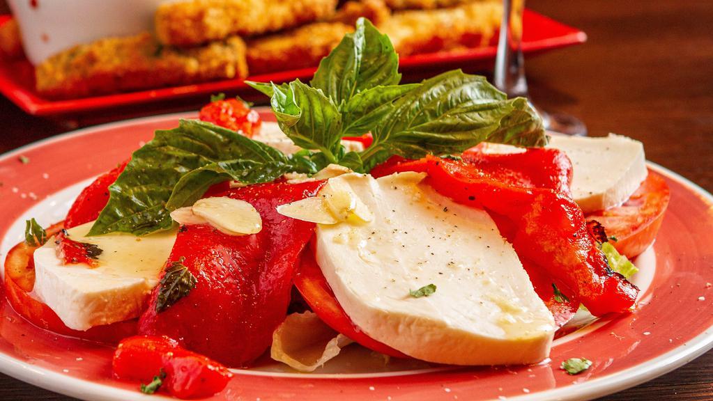 Fresh Tomato With Mozzarella & Roasted Peppers · Homemade Mozzarella layered with fresh sliced tomatoes, marinated roasted peppers and basil, drizzled with EVOO and balsamic reduction.