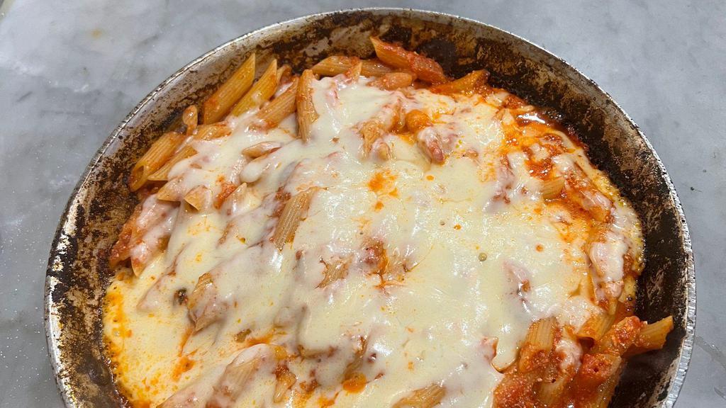 Baked Ziti · Baked dish. penne pasta smothered in ricotta cheese and marinara sauce topped with melted mozzarella baked at 500 degrees! served with a side salad and bread.