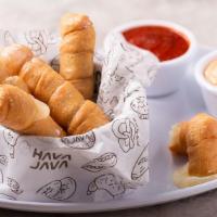 Mozzarella Coils · Crispy dough filled with melted mozzarella cheese. Served with marinara and blooming dipping...