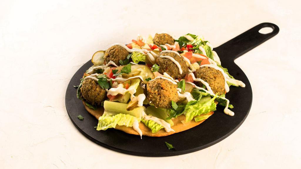 Falafel Salad Pizza · Gluten free crust, romaine lettuce, israeli salad, sour pickles, RR falafel balls, tahini drizzle.
