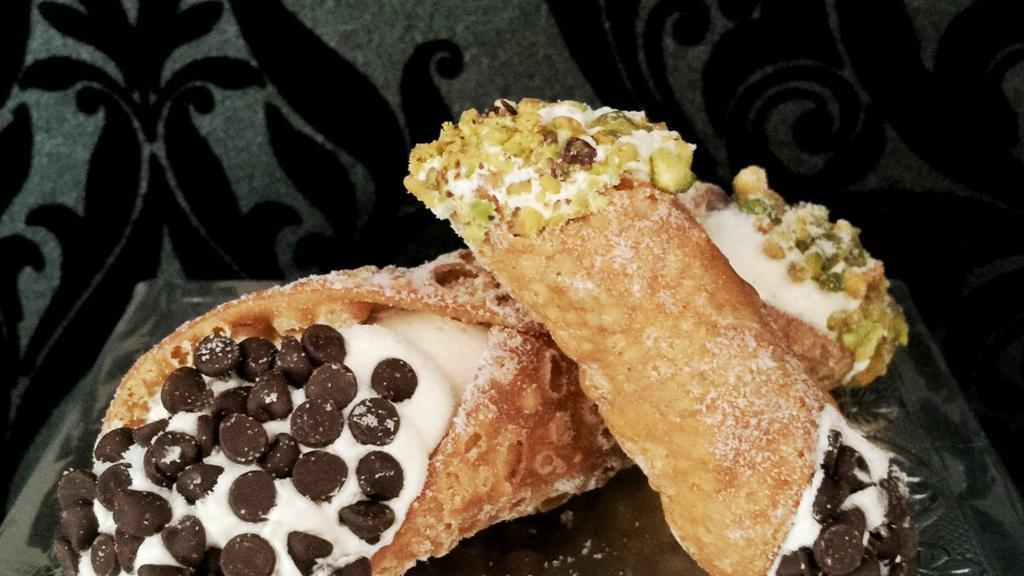 Cannoli · Large cannoli shell with homemade cannoli filling that we fill to the max!  Dusted with confectioners sugar and garnished with your choice of chocolate chips, pistachios or one side of each. Please specify when you order.