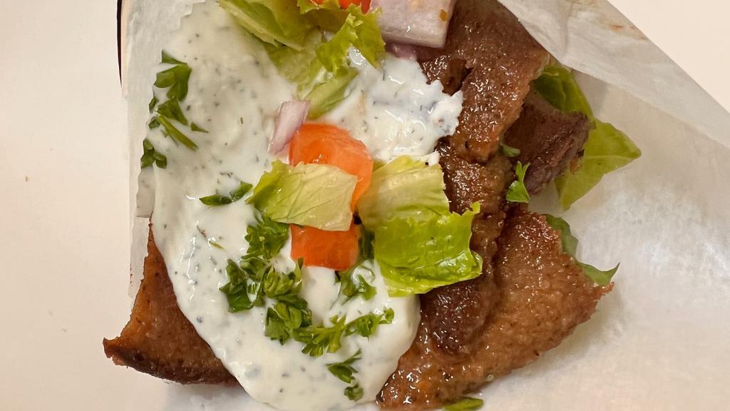 Beef & Lamb Gyro · Thin sliced beef and lamb gyro meat on pita bread, green lettuce, tomatoes, red onions, and tzatziki sauce.