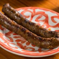 Side Merguez Sausage · House-made spicy lamb and beef sausage.