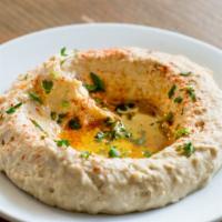 Hummus · Garnished with olive oil, paprika, and parsley
