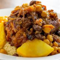 Lamb Shank Couscous · Served with vegetables, bouillon, chickpeas, caramelized onions and raisins