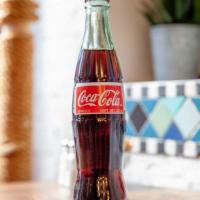 Coca Cola · 8oz bottle.