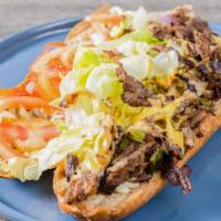 Philly Cheese Steak On A Hero · Pressed sandwich with grilled shredded steak, pepper, onion, mushroom, lettuce, tomato, mayo...