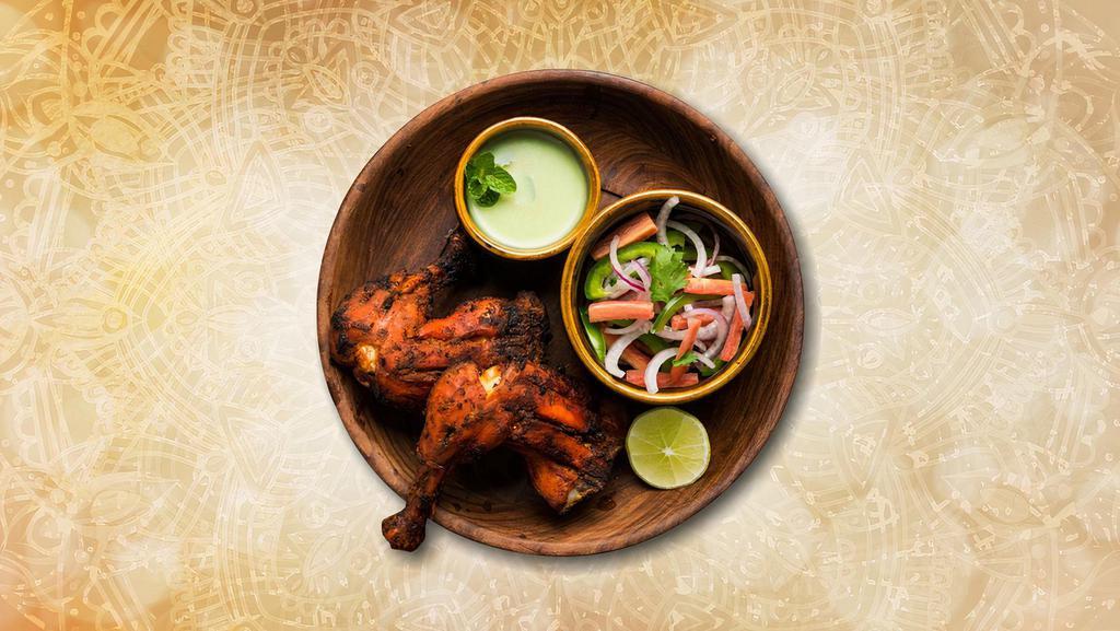 Charred Tandoori Chicken · Bone in chicken marinated in spicy yogurt sauce and char grilled in a traditional clay oven